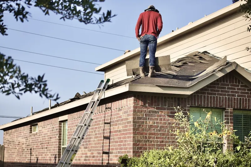 Professional roofer working on a residential roof in North Farmington